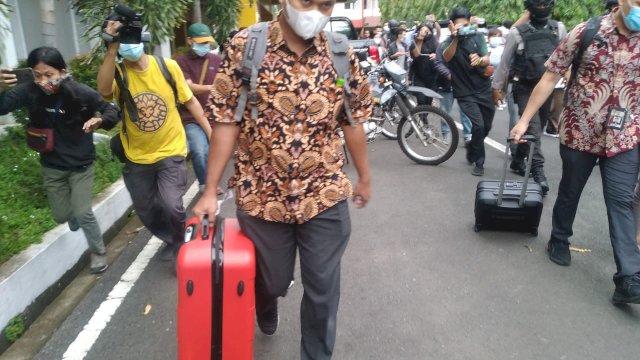 Petugas KPK membawa tiga koper hasil penggeledahan di Kantor Dinas PU Sulsel, Selasa (2/3/2021). 